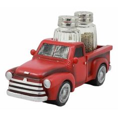 a red toy truck with two salt and pepper shakers