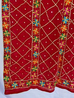 All over gotta patti phulkari work chinon silk dupatta is a perfect piece for Punjabi India Pakistani weddings, sangeet, jaago, mehndi or any festive occasion. Phulkari dupatta can be easily paired with almost any color for a beautiful contrasted look or Pair it with your jaago night dance party outfit. It is also unique gift for women on her birthday, mother’s day, or anniversary. Hand Embroidered Product Material: Chinon Silk Work: Silk Thread Phulkari, Needlework, Gotta Patti Work Pattern: Fl Festival Lehenga With Mirror Work And Nida Material, Festival Lehenga With Mirror Work In Nida Fabric, Festival Lehenga With Mirror Work In Nida, Red Kundan Dupatta With Mirror Work, Traditional Nida Dupatta With Mirror Work, Red Mirror Work Dupatta For Eid, Red Dupatta With Mirror Work For Eid, Red Kundan Dupatta With Cutdana, Festive Nida Dupatta With Mirror Work