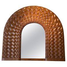 an arch shaped mirror is shown against a white background with wood grain patterning on it