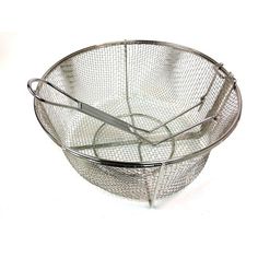 a metal basket with two tongs in it on a white surface, next to a pair of scissors