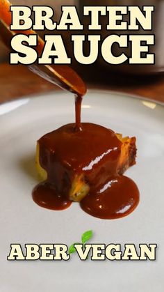 a plate with some food on it and sauce being drizzled over the top