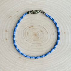 This is the Blueberry Beaded Anklet.  It is super cute, with lots of blueberry vibes!  This anklet is beautiful and elegant, yet also great for everyday casual wear. - It is fastened with antiqued bronze coated brass pieces, and is made with durable native glass seed beads. - My beads are always purchased here in Oklahoma from local native sellers. - It is 8.5" long with options for a 1" or 2" extender chain making it up to 10.5" long. *Note: Due to differences in device screens, the colors may Trendy Colorful Beaded Anklets As Gift, Blue Beaded Chain Bracelets For Beach, Trendy Anklets With Round Beads For Festivals, Adjustable Purple Beaded Bracelet With Beaded Chain, Adjustable Purple Beaded Chain Bracelets, Adjustable Purple Beaded Chain Bracelet, Casual Beaded Chain Bracelets For Summer, Handmade Blue Beaded Bracelets For Summer, Trendy Round Bead Anklets For Gift