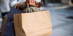 a woman carrying shopping bags on the street