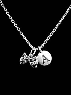 The charms are silver color. The mask charm is approx 12mm x 16mm. The chain is silver plated link chain and is 18" long. Has lobster clasp closure on the chain. Charms are Pewter. Chain made of silver plated alloy. Gorgeous!!!-Ships with gift packaging.-Invoices are not included in packages unless requested.-Birthstone charms can be purchased for this piece with this link:  https://www.etsy.com/listing/195923344-Initial/ Letter charms can be purchased for this pieces with this link:  https://ww Mardi Gras Necklace, Theater Mask, Comedy Tragedy Masks, Mother Daughter Necklaces Set, Tragedy Mask, Theatre Masks, Comedy And Tragedy, Mother Daughter Necklace, Mask Necklace