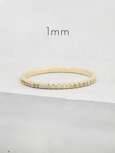 "Eternity rings are symbolic of eternal love, however, over the years, they've become a staple in stacking rings and can be worn by anyone - whether you are married, single, in a relationship or \"it's complicated.\" Its a gorgeous, simple band that really makes a statement! Stack them on one finger for a traditional look or wear one on each finger for a more fashion forward look. This ring has become a staple temporary wedding band for most of my clients! They love taking it on vacation or whil Promise Eternity Band In Brilliant Cut Yellow Gold, Yellow Gold Eternity Band With Brilliant Cut For Promise, Minimalist Yellow Gold Eternity Band Promise Ring, Timeless Yellow Gold Eternity Band For Promise, Minimalist Yellow Gold Eternity Band, Sterling Silver Cleaner, Jewelry Cleaning Solution, Simple Band, Chevron Ring