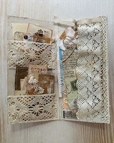 an open book with lace and paper on it