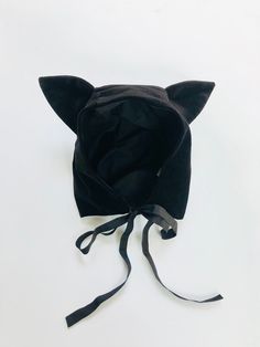 a black cat hat with ears on it