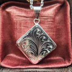 Metal: Sterling Silver Locket Size: 2.1cm x 2.1cm (side to side) Locket Size: 2.9cm x 2.9cm (point to point) Locket Weight: Approx 6.2 grams Hallmarked: Yes Chain Length: 18, 20, 22 or 24 inches Chain Weight: 4.9 grams - 6.3 grams Hallmarked: No (under 7.78 grams) A fabulous quality square / kite / diamond shaped locket with an engraved floral spray design the front. The locket is made from solid sterling silver and it has two spaces inside for photos. Available on a sturdy silver belcher chain Kite Diamond, Silver Locket Necklace, Belcher Chain, Sterling Silver Locket, Silver Locket, Floral Spray, Silver Lockets, Photo Locket, Diamond Shaped