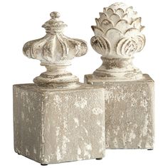 two cement vases sitting on top of each other in front of a white background