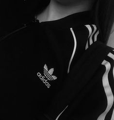 black and white photo of woman wearing adidas hoodie