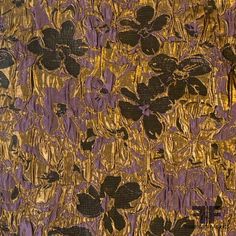 an abstract painting with gold and black flowers on purple fabric, as well as metallic foil