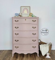 a pink chest of drawers next to a teddy bear