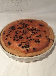 a pie sitting on top of a white table cloth