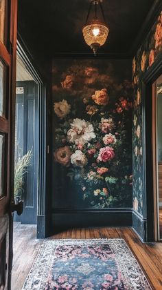 an ornate hallway with floral wallpaper and rug