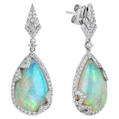 The Following Item we are offering is a Rare Important Radiant 18KT Gold Large Rare Fancy Gorgeous Opal Earrings. Earrings are comprised of LARGE Gorgeous Fancy Opals surrounded and adorned with Beautiful Glittering Diamonds!!! T.C.W. Approx 10CTS!!! These Gorgeous Earrings a Rare Sample Pair from a Private Manufacturer that sold to Important 5 Star Hotel and Fine Jewelry Stores. NWT Retail Price: $15,000.00!! Luxury Heirloom Gemstone Earrings, Luxury Exquisite Gemstone Earrings, Mens Diamond Jewelry, Jewelry Design Drawing, Semi Precious Jewelry, Style Deco, Star Hotel, Emerald Jewelry, Opal Earrings