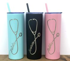 three different colored tumblers with stethoscopes on them