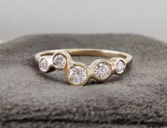 a gold ring with three diamonds on it