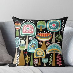 an artisticly designed pillow on a couch with pillows and throw pillows in the shape of mushrooms