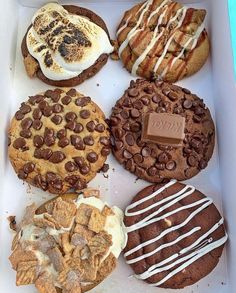 a box filled with lots of different types of cookies and desserts on top of each other