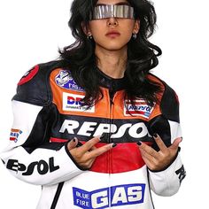 a woman in a racing suit with goggles on her head and hands folded out