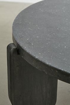 a close up of a black table with a white wall in the background