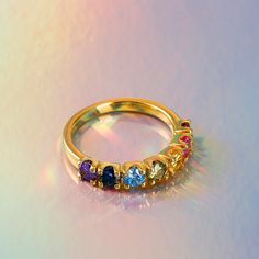 Marvelously divine, this ring is for the woman with impeccable style. Seven shimmering multi-colored round stones set in sterling silver, come together to create this fabulous ring. The glamorous stones glimmers in the light revealing a rainbow of colours. Buffed to a brilliant luster, this ring showcases your unique personality.Carat Weight: 1.99 ctStone Size: 3.5 mmStone Type: Jeulia® StoneNumber of Stones: 7 Stone Shape: RoundStone Color: Citrine Yellow, Sapphire Blue, Aquamarine Blue, Garnet Red, Amethyst Purple, Peridot Green, FuchsiaWeight: 3.11 gMaterial: 925 SilverPlating Color: Yellow Gold Fine Jewelry Rainbow Multi-stone Rings, Multicolor Multi-stone Birthstone Ring Fine Jewelry, Rainbow Multi-stone Birthstone Ring For Anniversary, Elegant Multicolor Multi-stone Birthstone Ring, Anniversary Multi-stone Rainbow Birthstone Ring, Anniversary Rainbow Multi-stone Birthstone Ring, Rainbow Multi-stone Round Sapphire Ring, Rainbow Birthstone Rings In Fine Jewelry, Multicolor Sapphire Birthstone Promise Ring