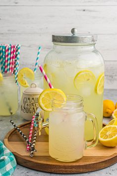 two mason jars filled with lemonade on a cutting board