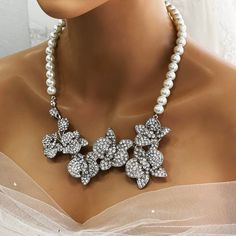 Elevate your bridal look with our Bridal Statement Earrings Necklace Set. Crafted with stunning crystal pearls and intricate orchid flowers, this unique wedding jewelry set adds a touch of elegance to your special day. Designed as the perfect gift for brides, each piece reflects meticulous attention to detail and timeless beauty. Let our set be a cherished part of your unforgettable moments. Embrace authenticity and sparkle with this exquisite ensemble. Dazzle on your special day with our exquis Unique Wedding Jewelry, Bridal Statement Earrings, Shoulder Jewelry, Earrings Necklace Set, Wedding Jewelry Set, Orchid Flowers, Bridal Look, Orchid Flower, Wedding Jewelry Sets