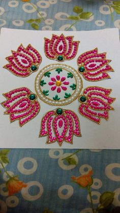 an intricately decorated card with pink flowers on it