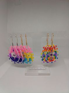 three different colored beaded items in a display case