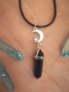 🖤 Here is a beautiful Black obsidian necklace, on a black 20 inch adjustable faux leather cord. With a silver Moon & Star charm!  🖤Enjoy the protective ground benefits of wearing this crystal pendant!   *Please choose your preferred finish from the drop down menu- *Faux leather cord - 20inch Silver plated -20 inch Stainless Steel -20 inch Mystical Nickel-free Black Jewelry, Mystical Black Nickel-free Jewelry, Black Nickel-free Mystical Jewelry, Mystical Black Necklace For Gift, Mystical Black Jewelry Gift, Mystical Black Jewelry For Gifts, Black Mystical Choker Necklace, Mystical Black Choker Necklace, Black Crystal Necklace With Adjustable Cord