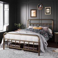 a bedroom with black walls and white bedding, along with an antique style metal frame