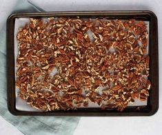 a tray filled with pecans sitting on top of a table