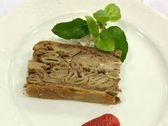 a piece of cake sitting on top of a white plate next to a strawberries