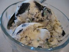 an ice cream sundae with oreo cookies in a glass bowl on a table