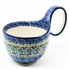 a blue and white bowl with a curved handle