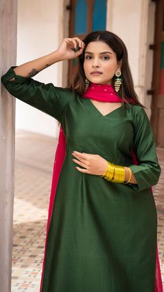 Bring on the festive spirit with our kurta set in chanderi silk. Fully lined kurta and pants. Made in chanderi silk. Dupatta in mul cotton with intricate tikki details. Color of Kurta + Pants : Dark Green. Color of Dupatta : Rani Pink. Model height is 5.3” and is wearing a size S. Wash Care : Dry Clean Only Slub Silk Kurta With Gota Work For Eid, Festive Slub Silk Sharara With Straight Kurta, Slub Silk Kurta With Cutdana For Diwali, Diwali Raw Silk Sharara With Straight Kurta, Festive Sharara With Straight Kurta In Slub Silk, Straight Kurta Churidar In Raw Silk With Cutdana, Semi-stitched Cotton Silk Kurta With Gota Work, Straight Kurta In Raw Silk With Gota Work, Straight Kurta In Raw Silk With Cutdana