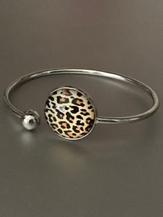 Leopard print stainless steel glass cabochon bangle bracelet    Will not tarnish lightweight to wear I have matching jewellery in this range  necklaces, rings earrings and keyrings :-) just search leopard print !!  Also in other designs Trendy Stainless Steel Jewelry As Fashion Accessory, Stainless Steel Bracelet Fashion Jewelry, Trendy Adjustable Circle Jewelry, Trendy Round Alloy Jewelry, Trendy Round Jewelry As Gift, Trendy Round Jewelry For Gift, Trendy Round Jewelry For Gifts, Trendy Nickel-free Round Jewelry, Gift Alloy Bangle