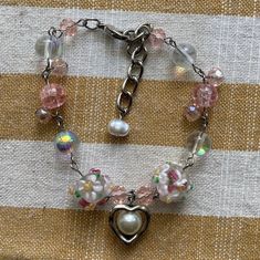 -Pink heart charm bracelet - Adjustable length - Beautiful addition to any outfit Pink Heart-shaped Beaded Bracelets With Charms, Vintage Bracelet Jewelry For Spring, Vintage Spring Bracelet Jewelry, Vintage Spring Jewelry Bracelet, Pink Beaded Charms Bracelets For Valentine's Day, Pink Beaded Bracelets With Charms For Valentine's Day, Valentine's Day Pink Beaded Bracelets With Charms, Pink Heart-shaped Jewelry For Friendship, Pink Charm Bracelet For Friendship With Lobster Clasp