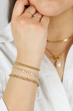 Our Adela Twist Bracelet is a beautiful rope chain that is a versatile piece that can be worn on it's own or paired with other jewelry for a layered look. This bracelet adds the perfect touch of chic and luxury. To complete the look pair it with our Elisa Layered Necklace. THE DETAILS Color: PVD 18K Gold PlatedMaterial: Stainless SteelSize: 5mm Thick x 17cm With 5cm Extender READ HOW TO CARE FOR JEWELRY HERE Bracelets Style, Gold Collection, Trendy Designs, Layered Necklace