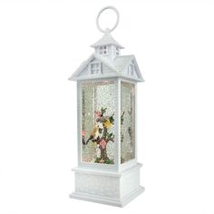 a white lantern with flowers and birds in it