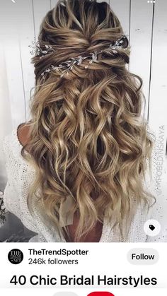 the back of a woman's head with wavy hair and braids in it