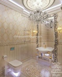 an elegant bathroom with chandelier, toilet and sink in white tile flooring