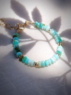 This blue Peruvian Opal bracelet will create soothing energy, reduce tension, and increase confidence. It also has the ability to encourage new ideas and clear unnecessary thoughts. Reduce your stress with this unique tropical beauty.✦ DETAILS ✦✧ Name: Mana'olana - (mah-nah-o-lah-nah) - hope, expectation, confidence.✧ Adjustable length: 6.5"- 8".✧ Blue Peruvian Opal.✧ Gold Filled components and clasp.✧ All Ke Aloha Jewelry pieces come packaged thoughtfully, beautifully, and ready for gift giving Spiritual Turquoise Beaded Hypoallergenic Bracelet, Turquoise Hand-wrapped Jewelry For Meditation, Bohemian Amazonite Bracelets As Gift, Handmade Rondelle Beaded Bracelets For Healing, Handmade Fusion Bracelet For Healing, Everyday Blue Amazonite Bracelets, Spiritual Amazonite Bracelet For Everyday, Handmade Blue Amazonite Beaded Bracelets, Handmade Amazonite Bracelets As Gift