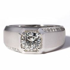 a white gold diamond ring with channeled diamonds on the sides and an engagement band