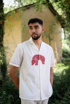 We have a crush on this shirt, because of its kooky hand detailed hand embroidered applique. Crafted in cotton, it also features embroidery details on the sleeves. This product is handcrafted in Pune, India. Subtle variations in patterns are natural to this process. We believe this makes each creation unique and charming. Men Shirts Embroidery, Mens Shirt Illustration, Mens Shirts Design Ideas, Cloth Painting Ideas, Men Embroidery Shirts, Painted Shirts Diy, Embroidery Designs Shirts, Shirt Embroidery Ideas For Men, Embroidery Shirt Ideas