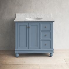 a white sink sitting on top of a blue cabinet