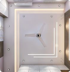 a room with a ceiling fan in the center and some lights on it's sides