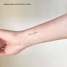 a person's arm with a small tattoo on the left side of their arm