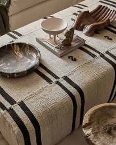 a table topped with plates and bowls on top of a rug